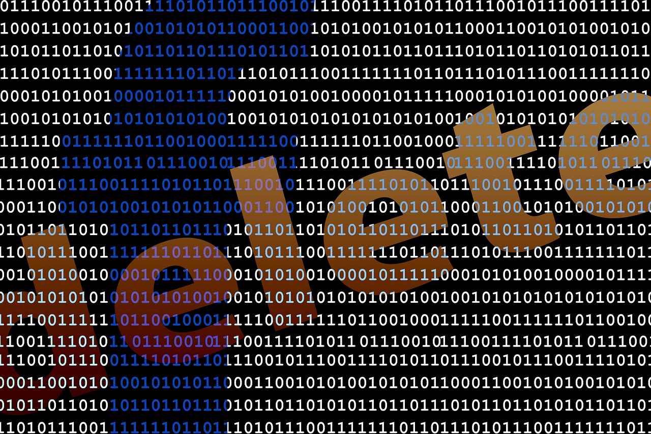 a screen of binary code with the word delete written in diagonal letters across it